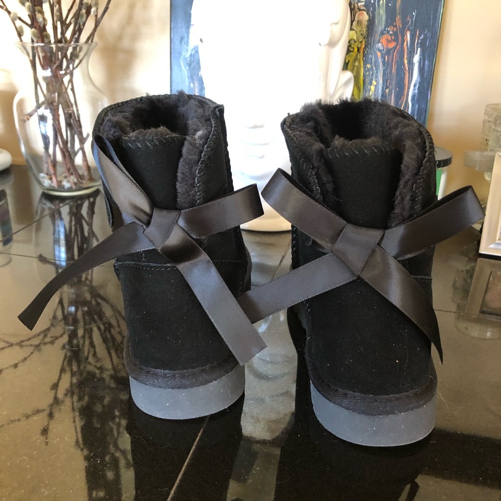 NWOT Black boots with bows. Never worn.
